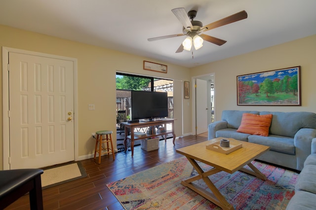 living area featuring baseboards, wood finished floors, and a ceiling fan