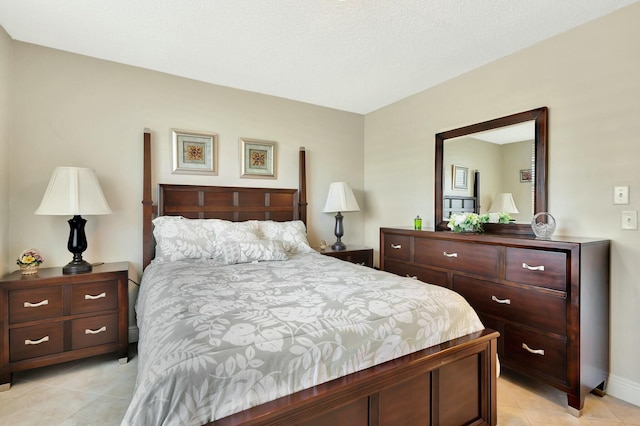 bedroom featuring light tile patterned floors and baseboards