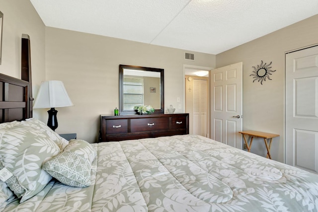 bedroom with visible vents and a textured ceiling