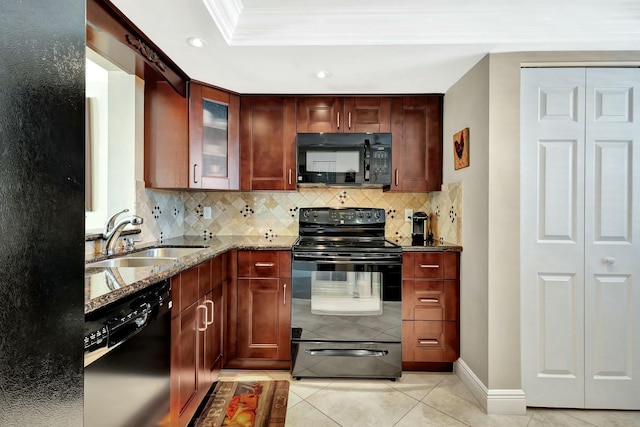 kitchen featuring stone counters, ornamental molding, decorative backsplash, black appliances, and a sink