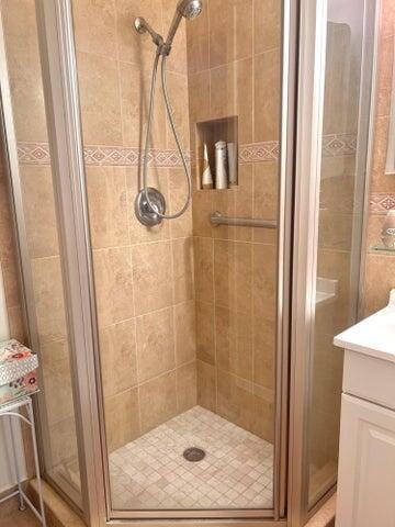 bathroom with vanity and a shower stall