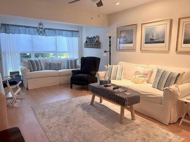 living area featuring a ceiling fan and wood finished floors