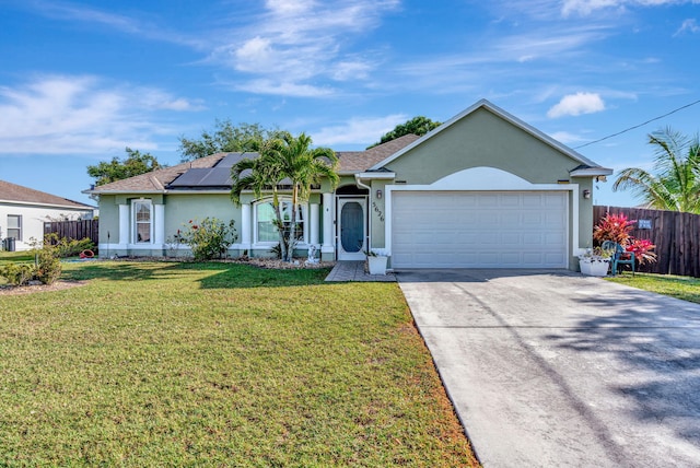 ranch-style house with solar panels, a front yard, driveway, and stucco siding