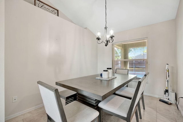 dining room with a chandelier, light tile patterned floors, baseboards, and vaulted ceiling