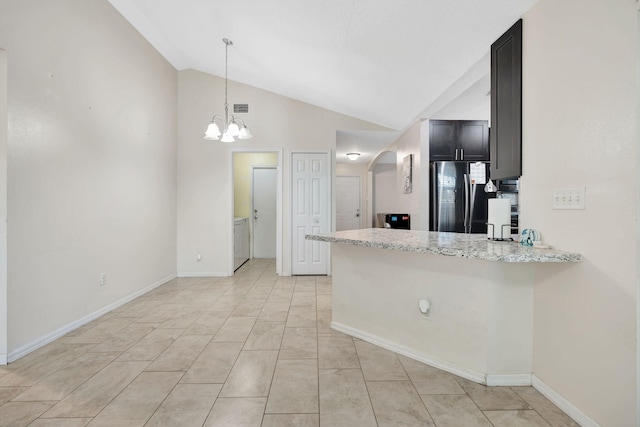 kitchen featuring visible vents, freestanding refrigerator, arched walkways, a peninsula, and lofted ceiling