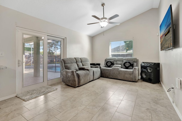 living room featuring baseboards, a ceiling fan, and lofted ceiling