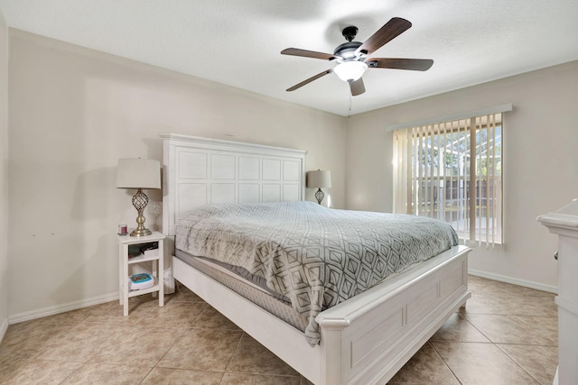 bedroom with light tile patterned flooring, baseboards, and ceiling fan