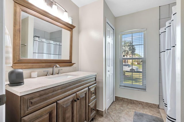 bathroom featuring vanity, a shower with curtain, baseboards, and tile patterned flooring