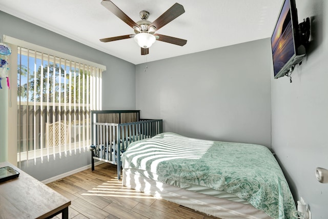 bedroom with ceiling fan and wood finished floors