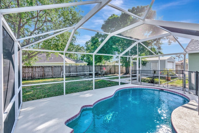 view of pool featuring a fenced in pool, a lanai, an outdoor structure, a fenced backyard, and a patio area