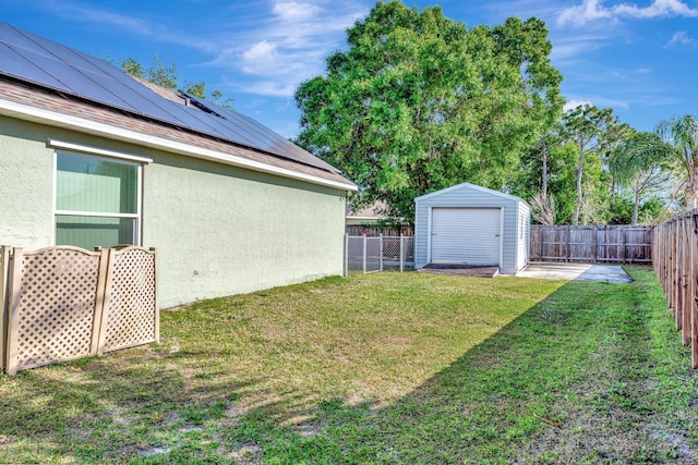 view of yard featuring a storage shed, an outdoor structure, and a fenced backyard