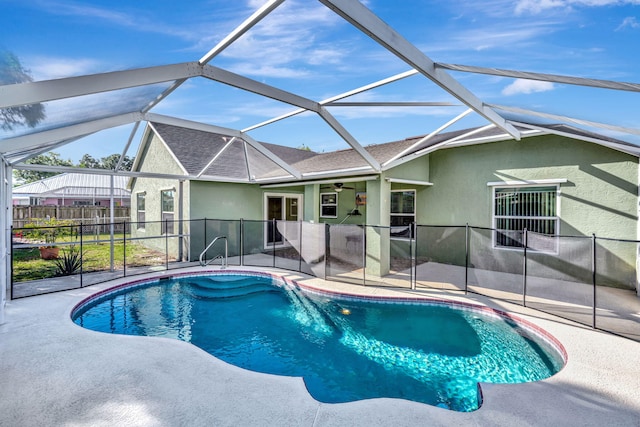 pool with a lanai, a patio, and fence