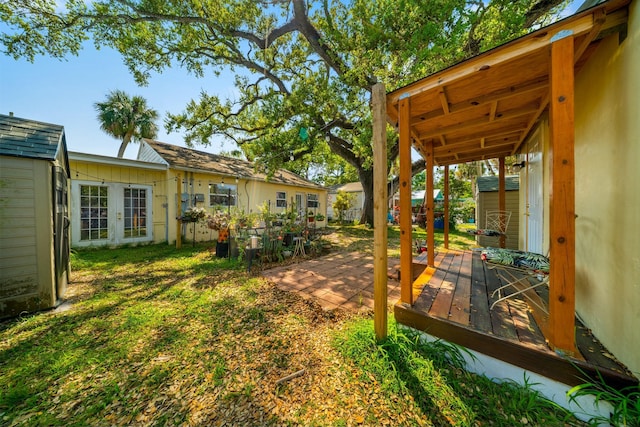 view of yard with french doors and a deck