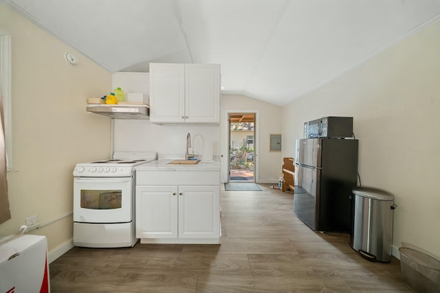 kitchen with under cabinet range hood, vaulted ceiling, freestanding refrigerator, electric stove, and open shelves