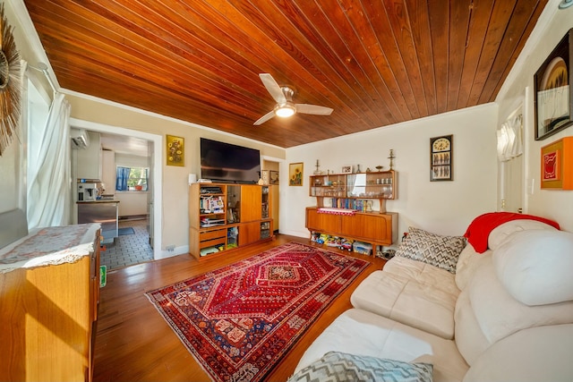 living area featuring wood ceiling, crown molding, ceiling fan, and wood finished floors