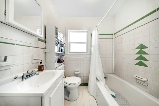 bathroom featuring toilet, tile patterned flooring, tile walls, shower / bath combination with curtain, and vanity