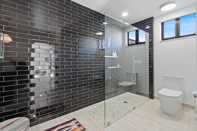 full bath featuring baseboards, toilet, and a walk in shower