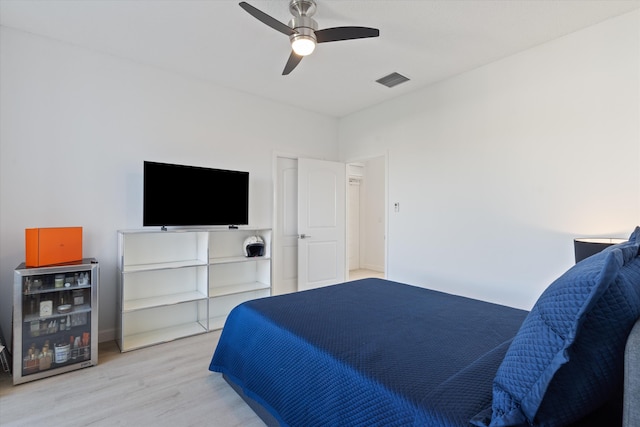 bedroom featuring visible vents, wood finished floors, and a ceiling fan