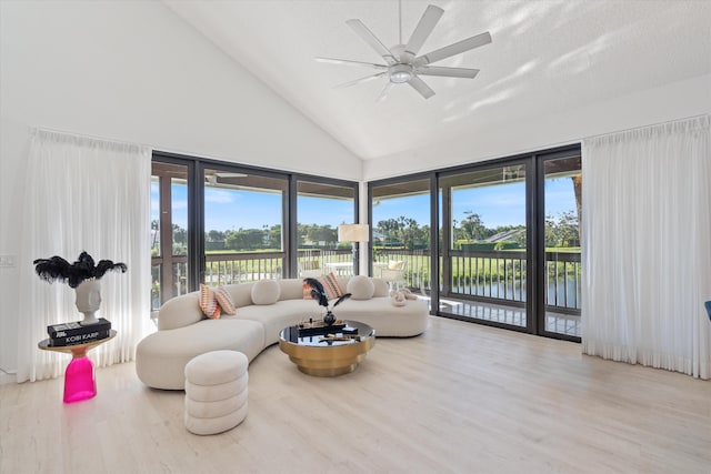 living room featuring high vaulted ceiling, a water view, ceiling fan, and wood finished floors