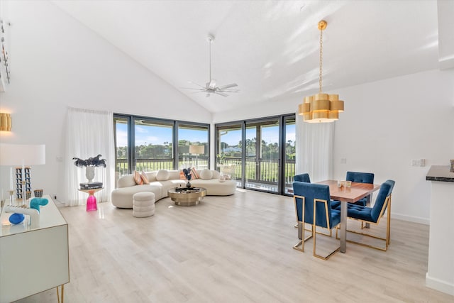 living room featuring a ceiling fan, baseboards, light wood-style floors, and high vaulted ceiling