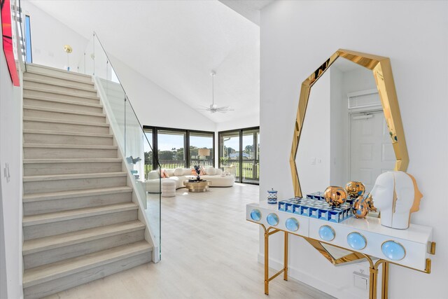 interior space featuring high vaulted ceiling, wood finished floors, and a ceiling fan