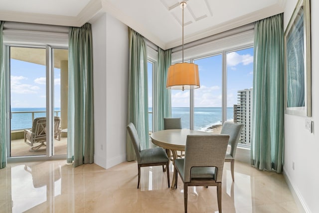 dining space with a healthy amount of sunlight, a water view, and ornamental molding