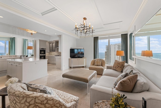 living area featuring a notable chandelier, recessed lighting, and ornamental molding