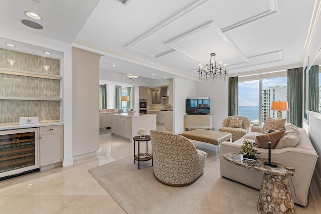 living room featuring beverage cooler, ornamental molding, recessed lighting, an inviting chandelier, and marble finish floor