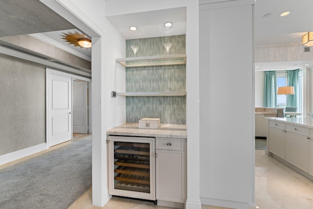 bar featuring recessed lighting, a bar, beverage cooler, and ornamental molding