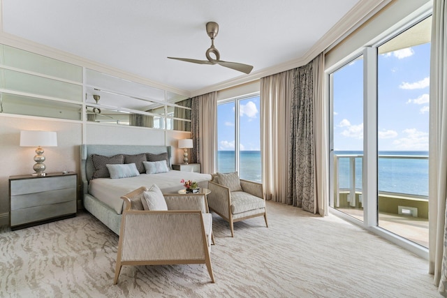 carpeted bedroom with ceiling fan, a water view, ornamental molding, and access to outside