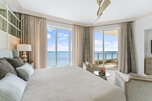 bedroom featuring crown molding, access to outside, and a water view