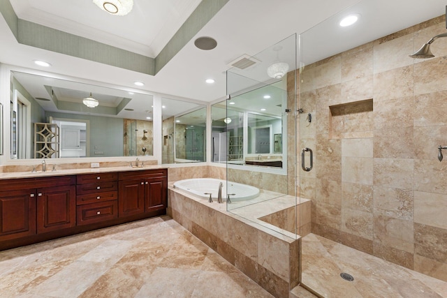 bathroom with a bath, a shower stall, crown molding, and a sink