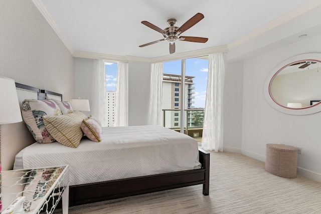 carpeted bedroom featuring crown molding, baseboards, and ceiling fan