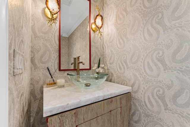 bathroom featuring visible vents, vanity, and ornamental molding