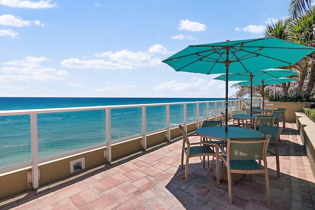 view of patio / terrace featuring outdoor dining space and a water view