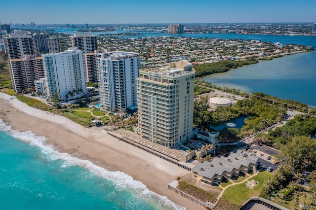 birds eye view of property with a view of the beach, a view of city, and a water view