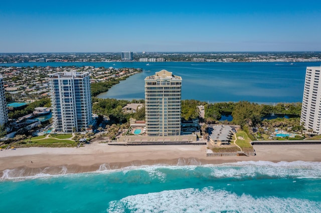 bird's eye view featuring a water view, a city view, and a view of the beach