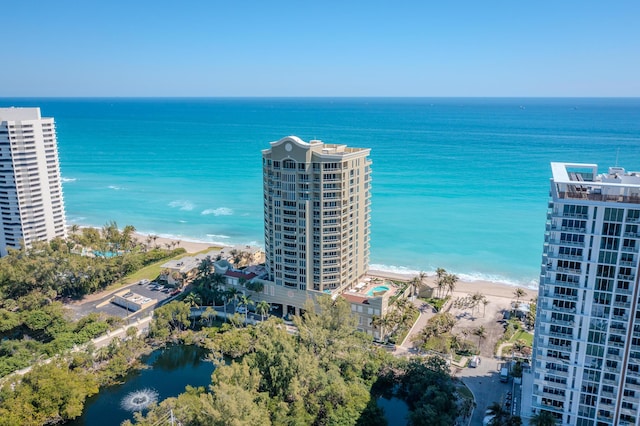 drone / aerial view featuring a view of the beach and a water view