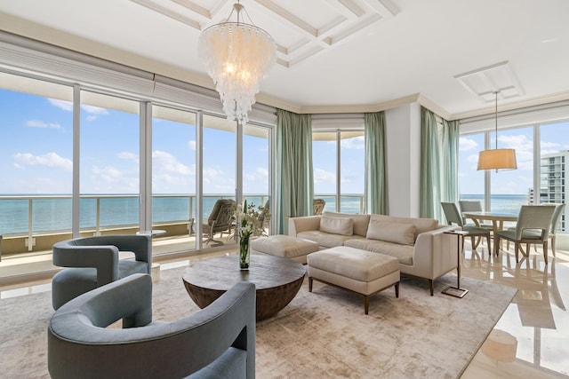 living area with a notable chandelier, plenty of natural light, and a water view