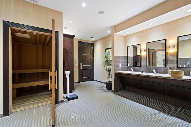 bathroom featuring recessed lighting and double vanity