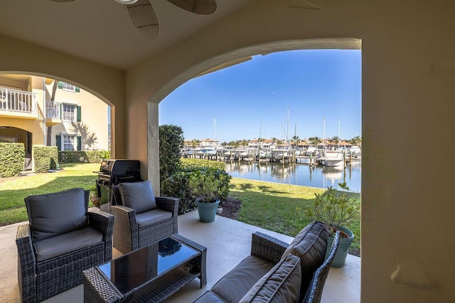 view of patio with outdoor lounge area, ceiling fan, a water view, and grilling area