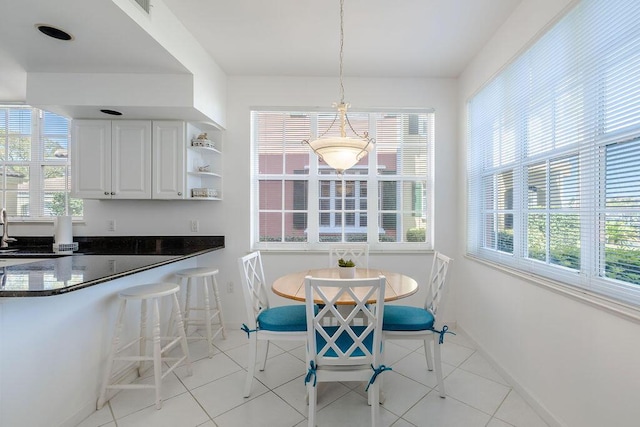 dining room with light tile patterned floors and baseboards