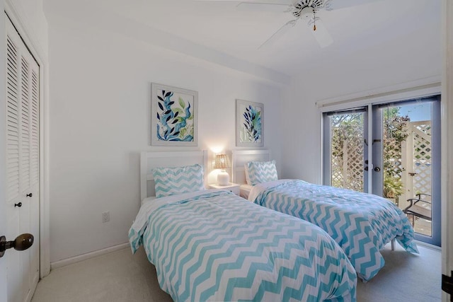 carpeted bedroom featuring a ceiling fan, access to exterior, baseboards, and a closet