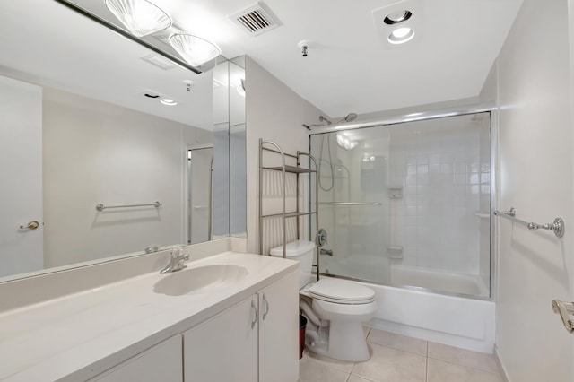 bathroom with tile patterned floors, visible vents, toilet, combined bath / shower with glass door, and vanity