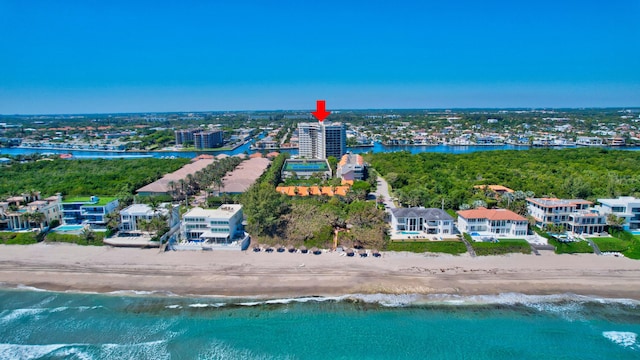 birds eye view of property featuring a beach view and a water view