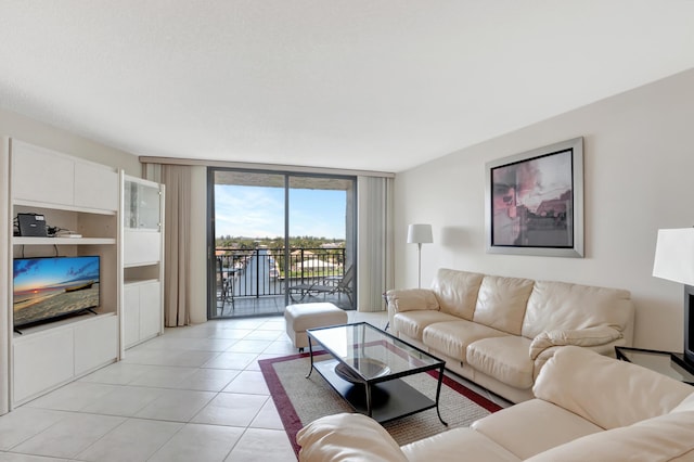 living area featuring light tile patterned floors and expansive windows