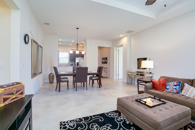 living area featuring a ceiling fan, recessed lighting, and visible vents