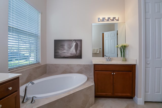 full bathroom featuring a closet, a garden tub, and vanity