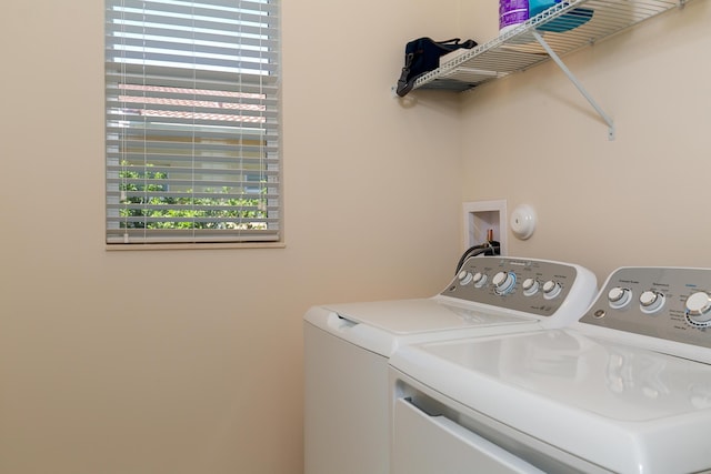 clothes washing area with washer and dryer and laundry area