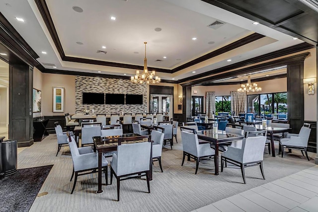 dining space featuring a tray ceiling, a notable chandelier, visible vents, and a wainscoted wall